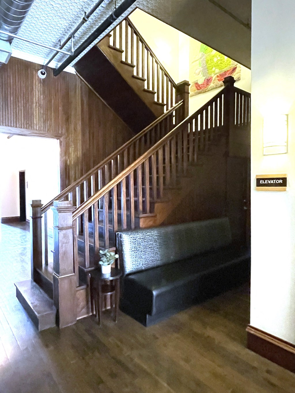 the stairs in the lobby of a building with a couch