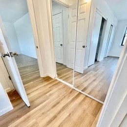a mirror in a room with a wooden floor
