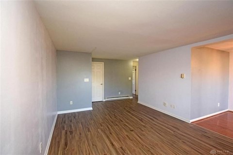 A room with wooden floors and white walls.