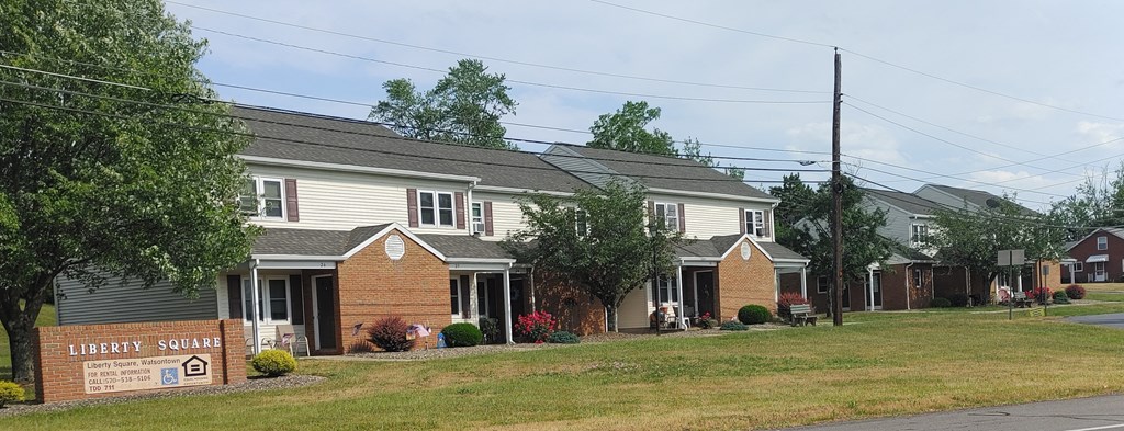 a row of houses with a sign in front of them