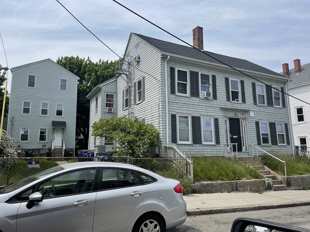 a silver car parked in front of a house