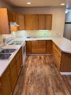 A kitchen with wooden cabinets and a white countertop.