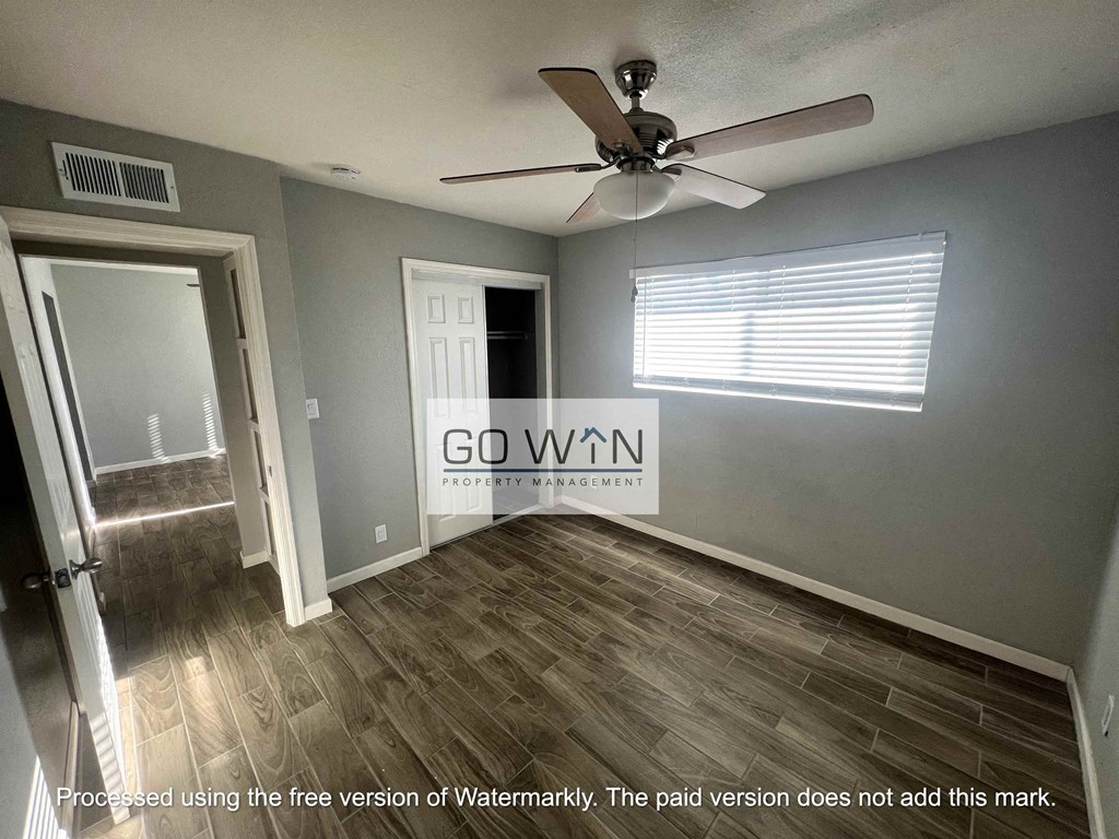 an empty room with a ceiling fan and  go win