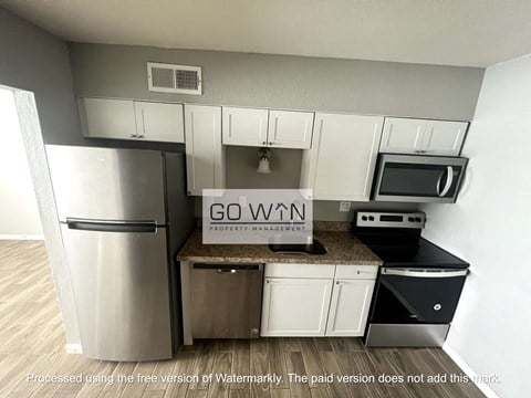 a kitchen with stainless steel appliances and a go win sign