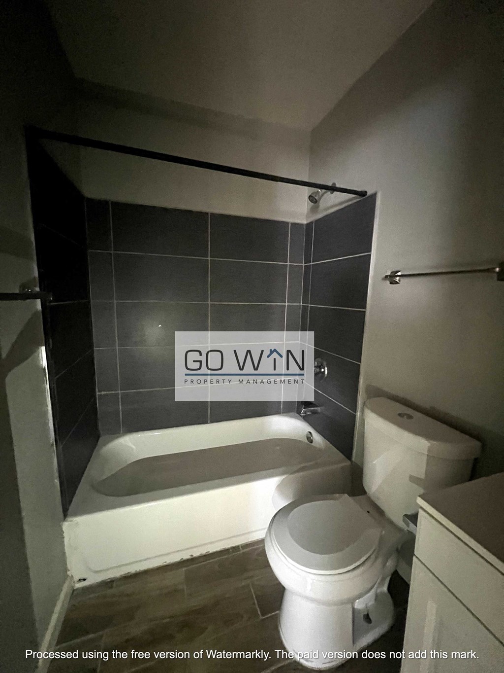 a bathroom with a toilet and a bath tub