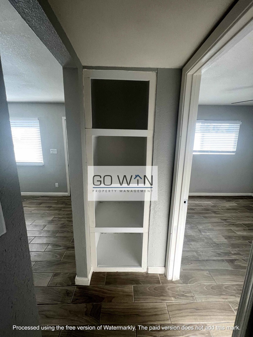 a go win sign on a book shelf in the hallway of a house