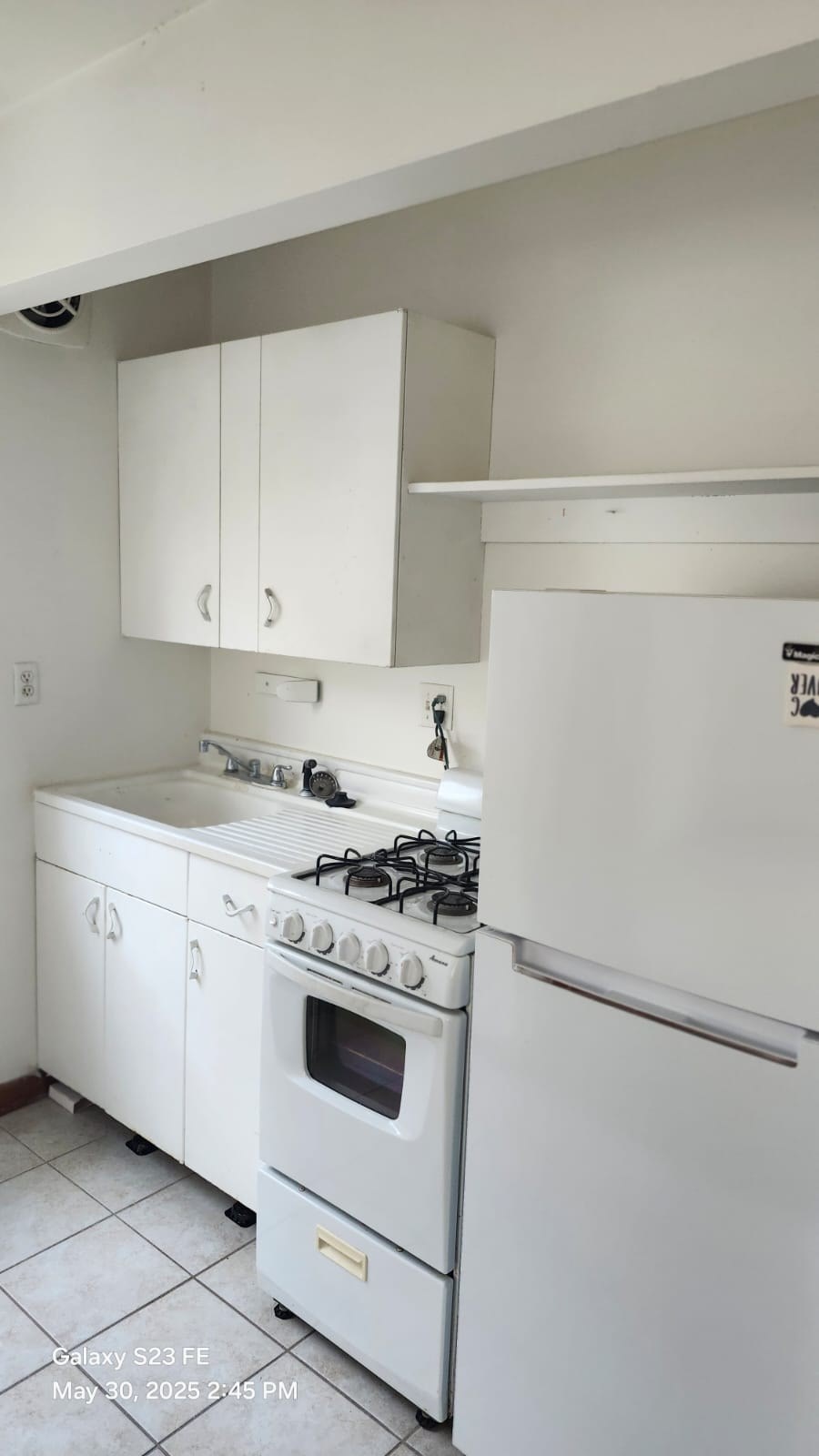 A white kitchen with a stove and oven.