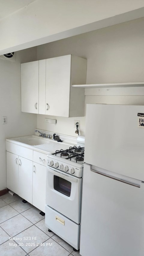 A white kitchen with a stove and oven.