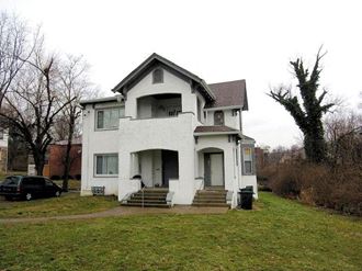 a white house sitting on top of a green field