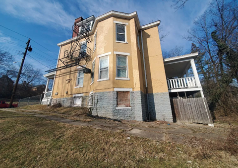 A two-story building with a yellow and blue exterior.