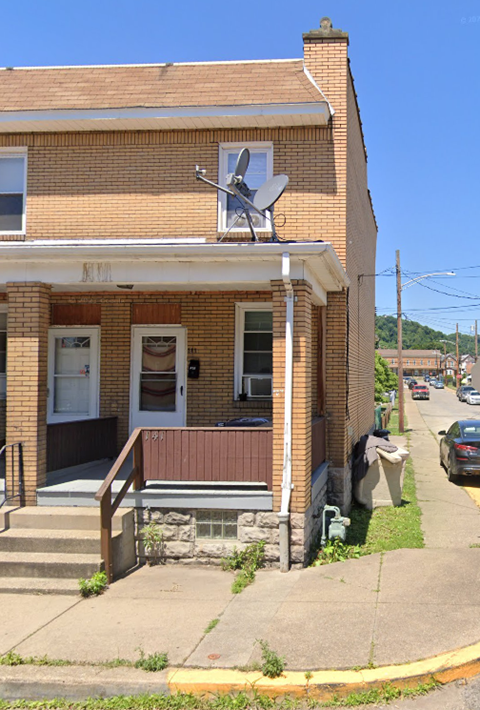 an old brick building with a satellite dish on top of it