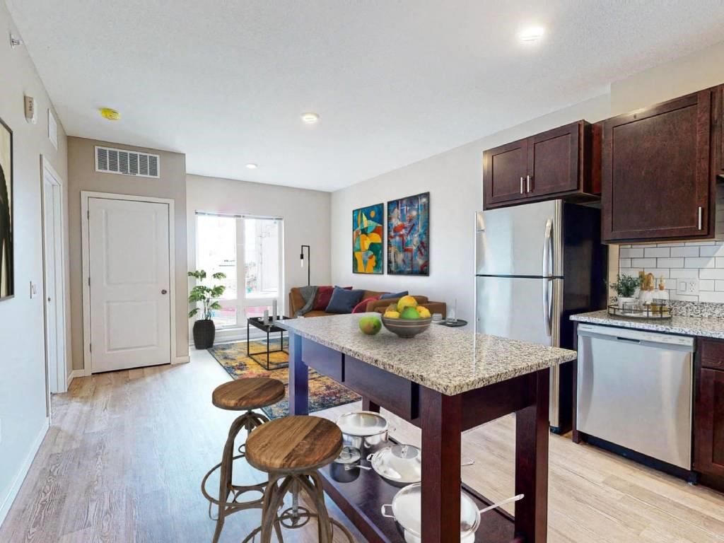 a kitchen and living room with a counter top
