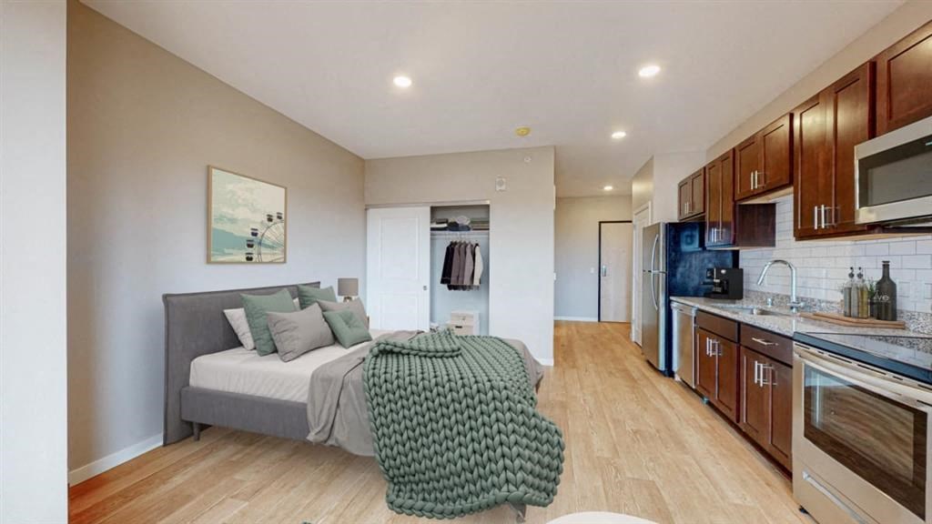 a living room and kitchen with a couch and a table