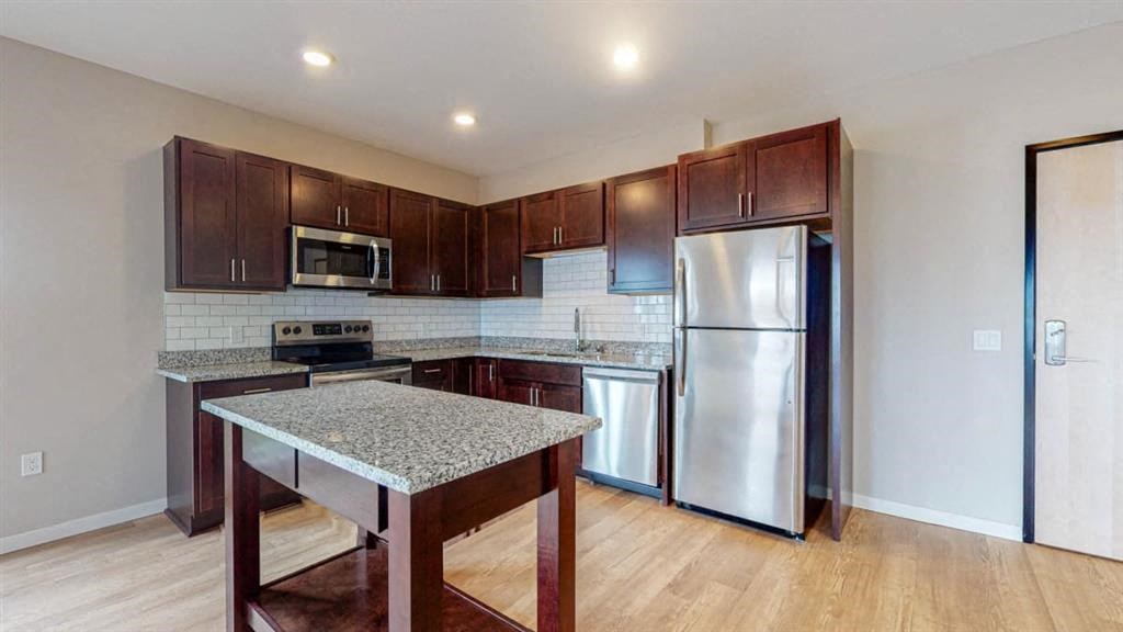 a kitchen with stainless steel appliances and granite counter tops