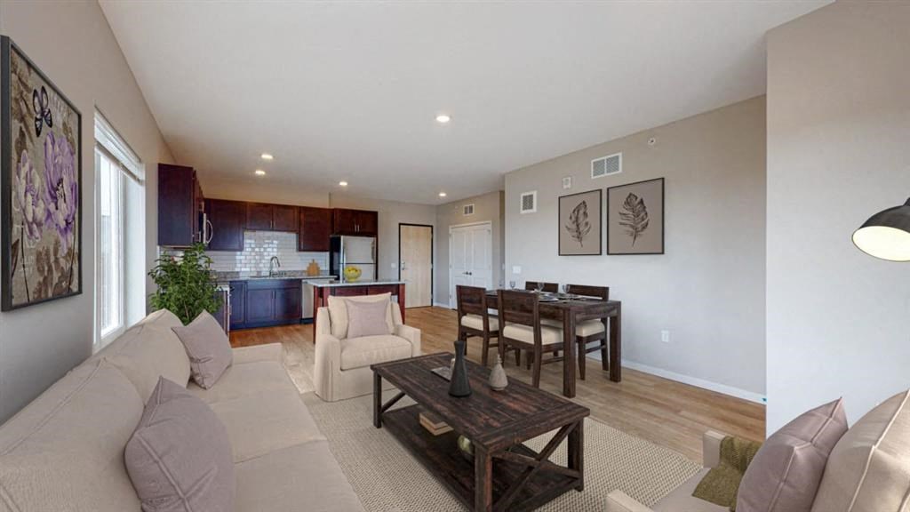 a living room with a couch and a table and a kitchen