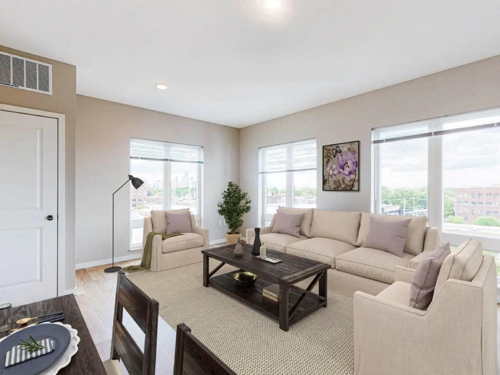 a living room with a couch and chairs and a table