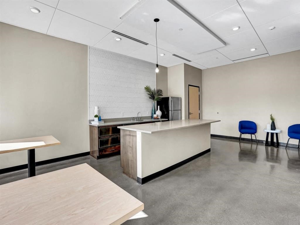 a large room with a desk and chairs