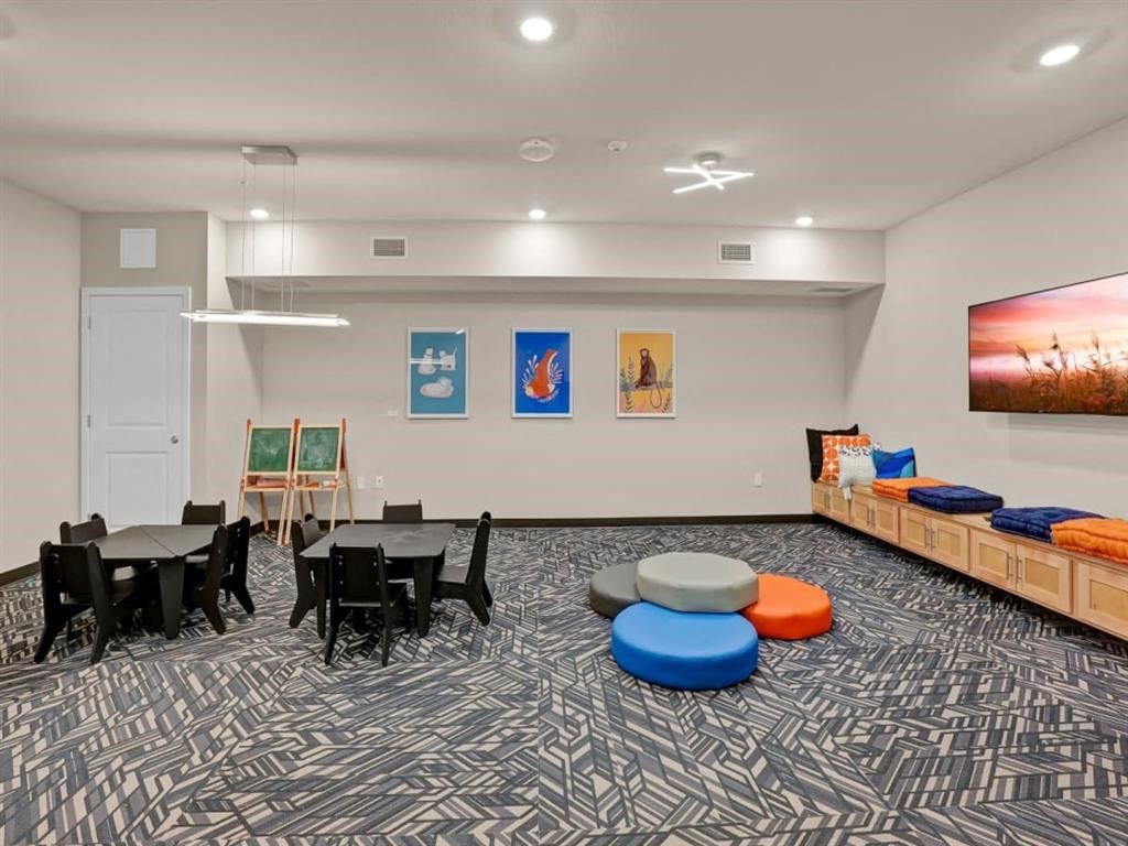 a game room with a table and chairs and a couch