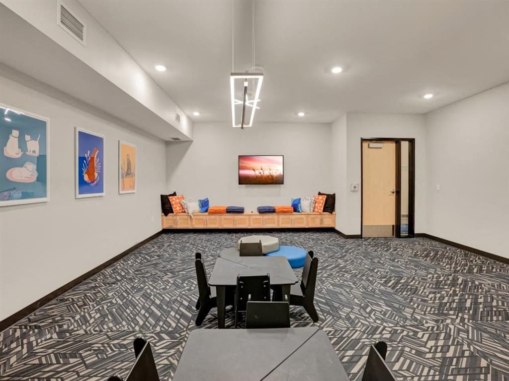 a conference room with a table and chairs in front of a door