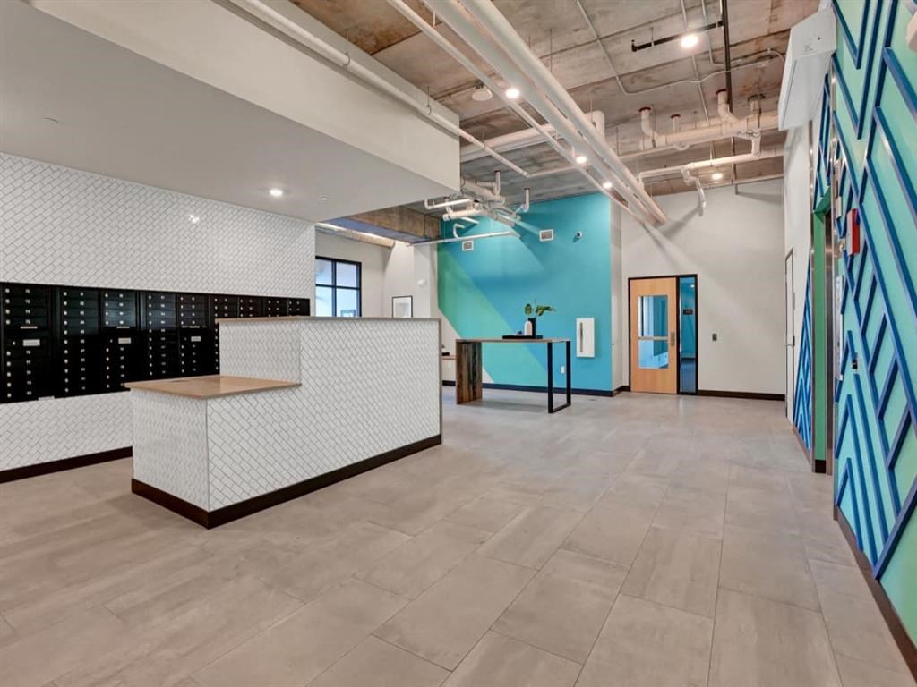 an open office space with a blue and white wall and a reception desk