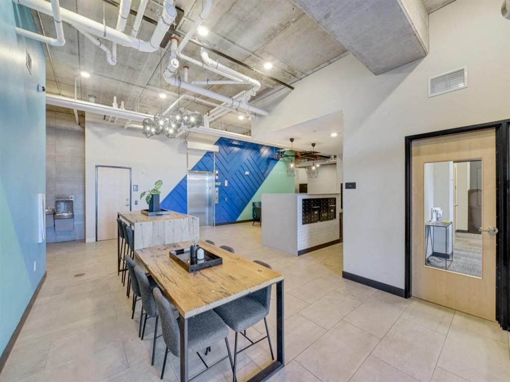 a conference room with a table and chairs and a blue wall