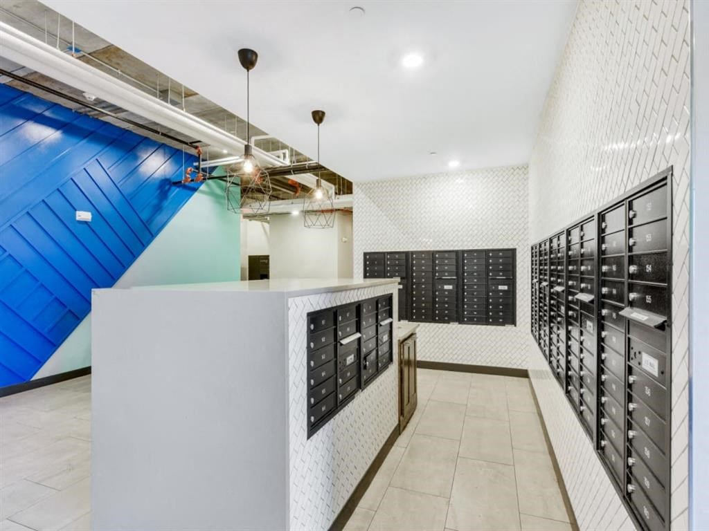 a tasting room with rows of wine racks and a counter