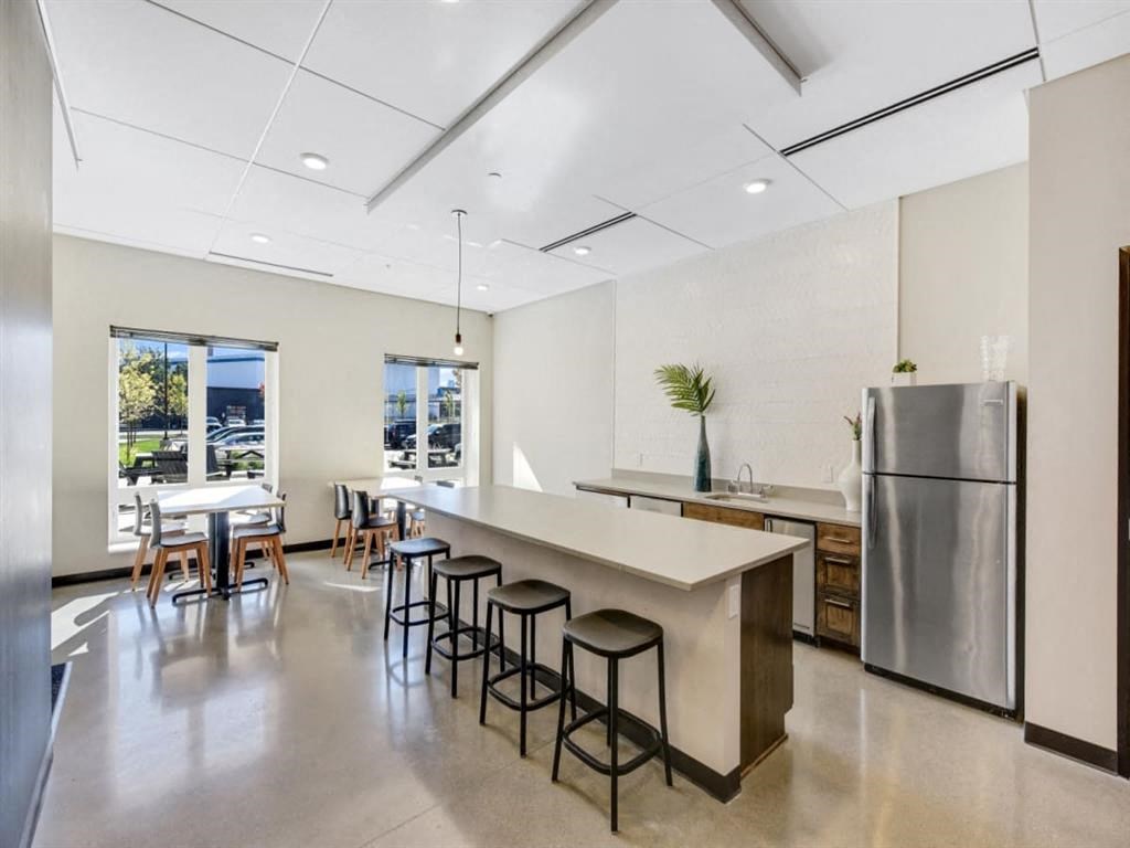 a large kitchen with a counter top and a refrigerator