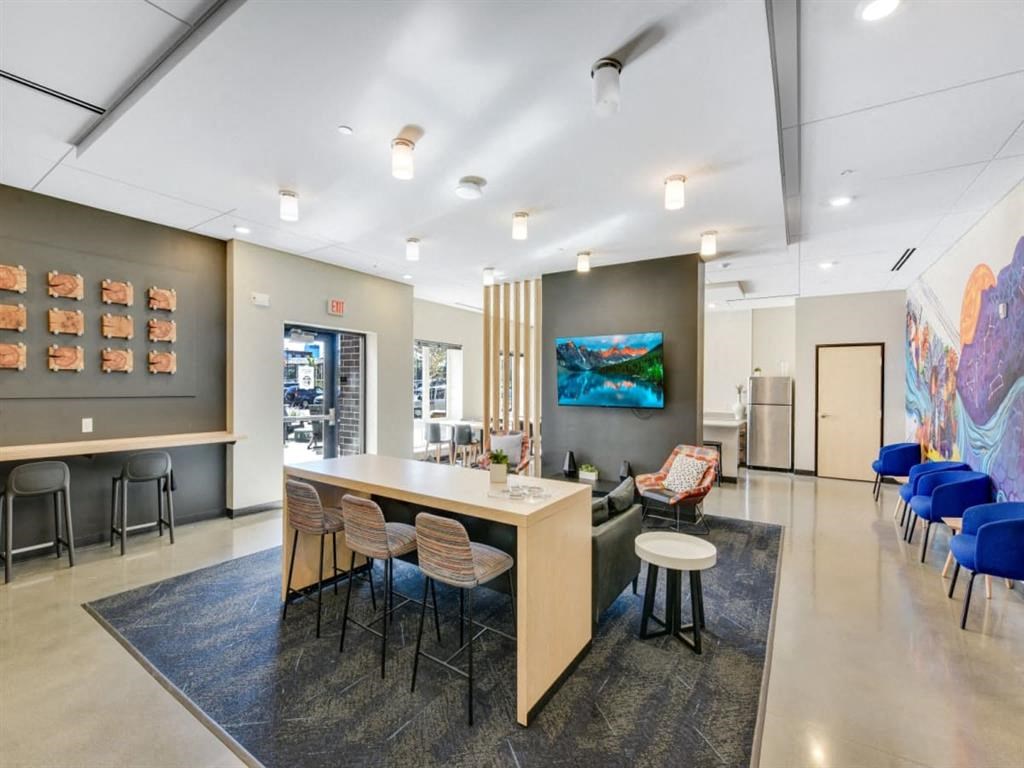 a room with a table and chairs and a lobby