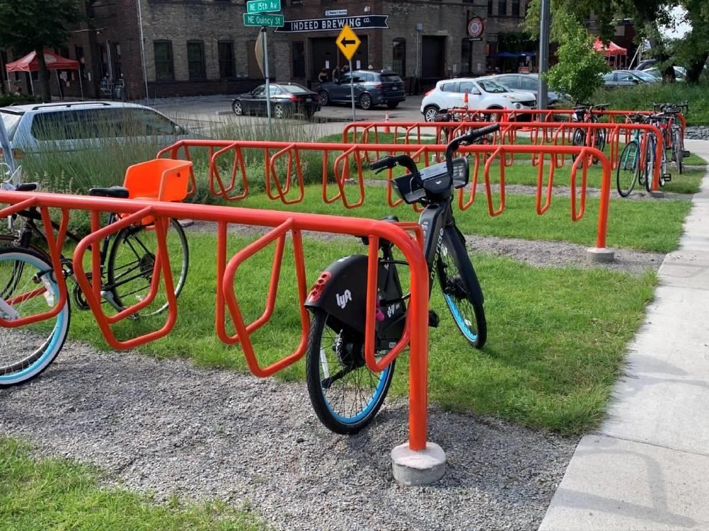 a bicycle parked in a rack in a park