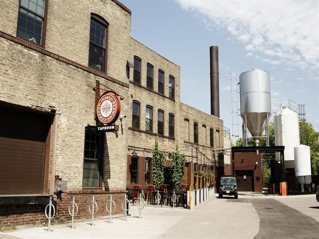 a large brick building with a factory and a truck