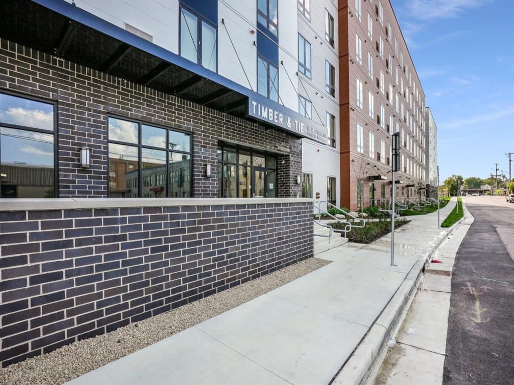 a brick building with a sidewalk in front of it