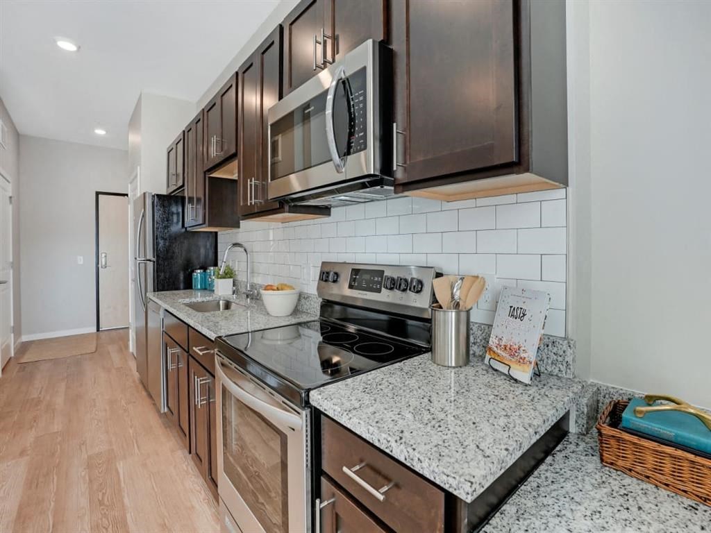 a kitchen with stainless steel appliances and granite counter tops