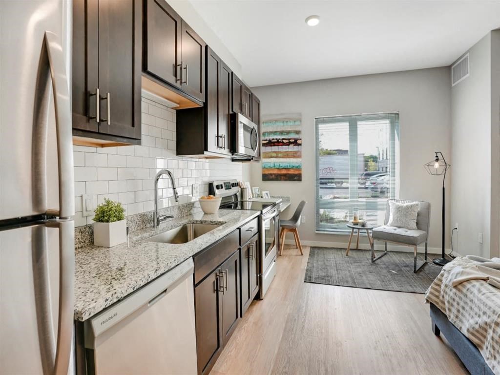 a kitchen with stainless steel appliances and granite counter tops