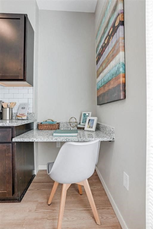 a small desk with a chair in a kitchen