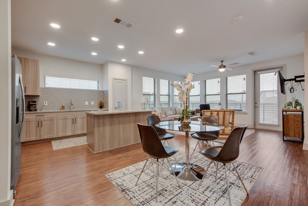 an open kitchen and dining room with a table and chairs