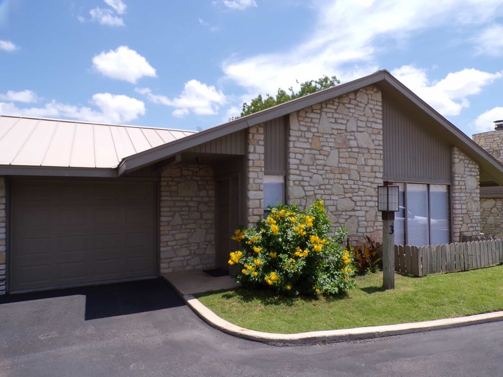 a house with a flowering in front of it