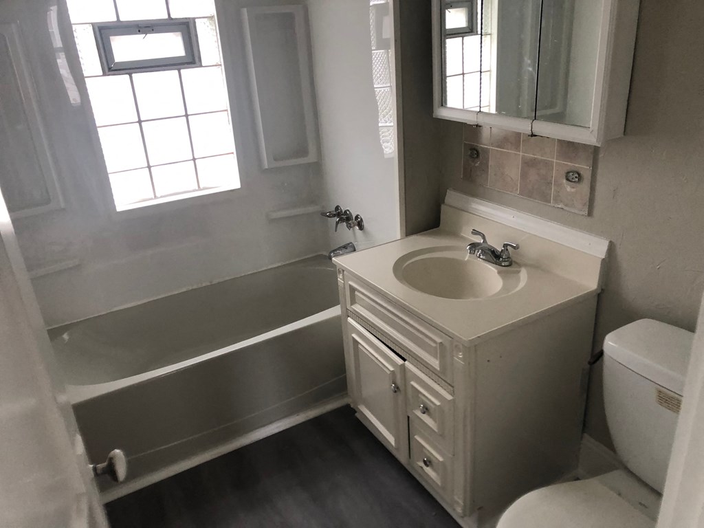 a small bathroom with a sink and a bath tub