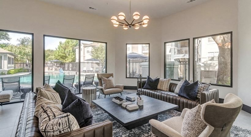 a living room with couches and chairs and a table