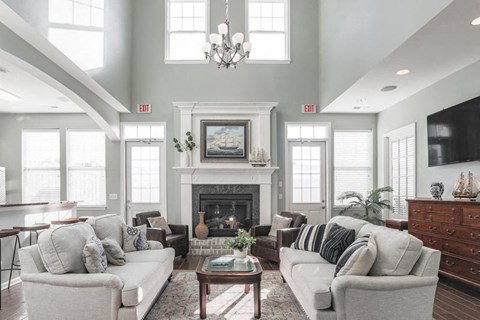 a living room with couches and chairs and a fireplace