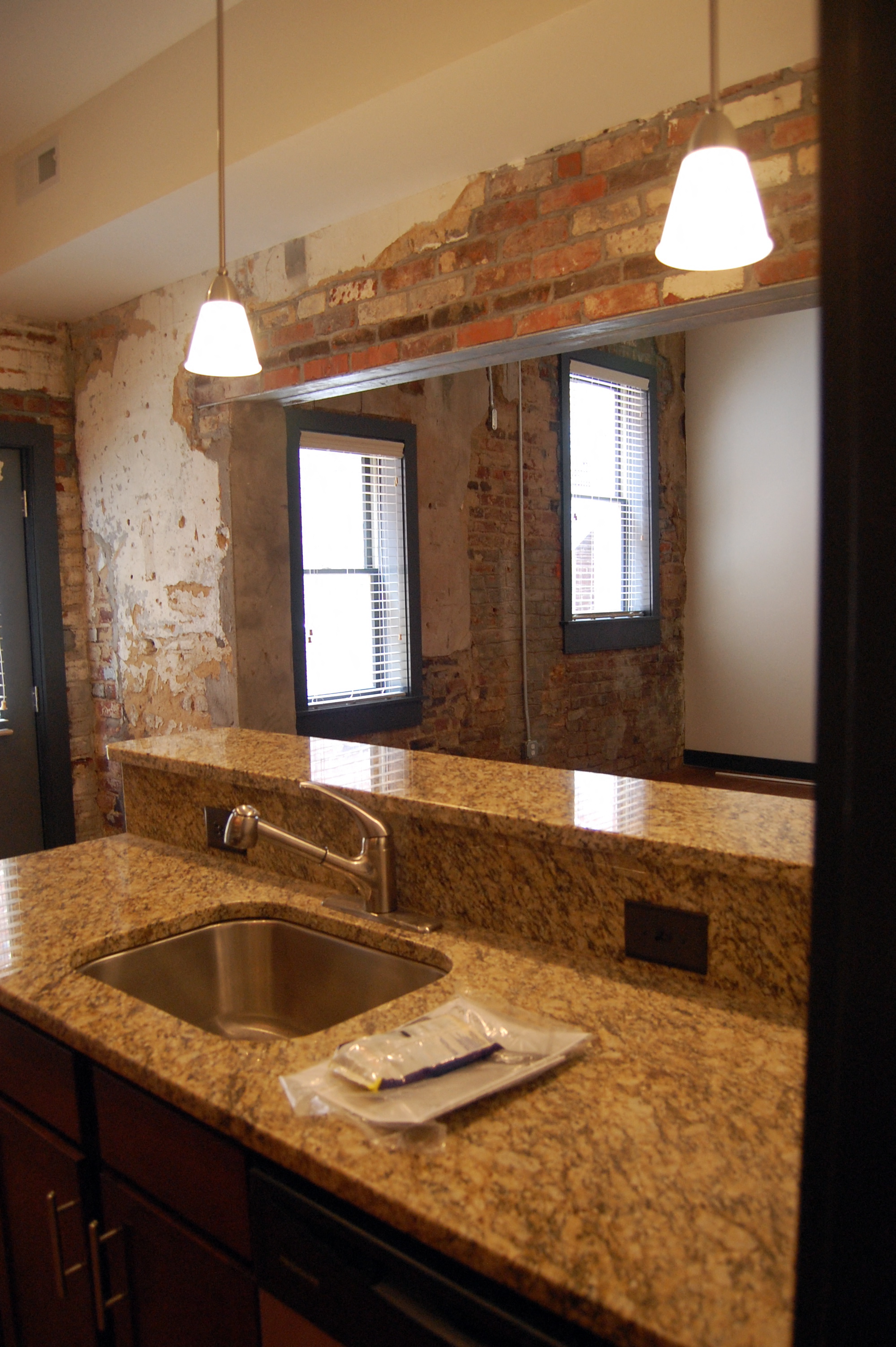 a kitchen with a sink and a granite counter top