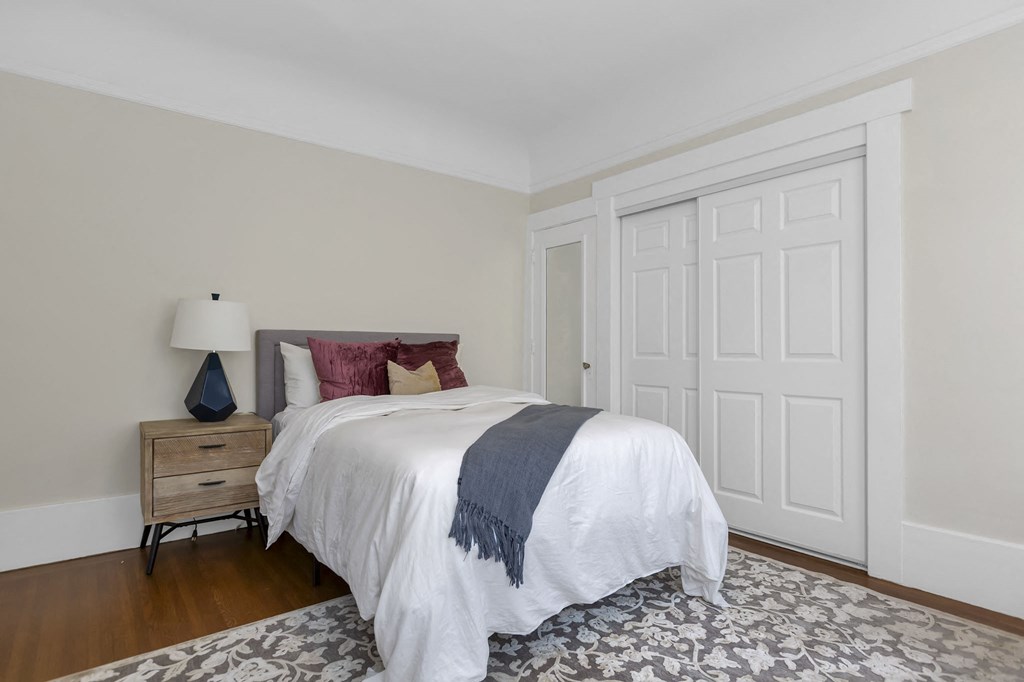 a bedroom with a bed and two closet doors