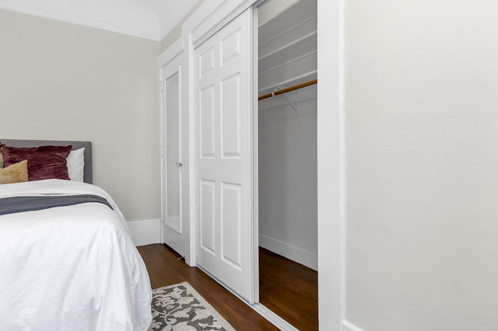 a bedroom with a bed and a closet