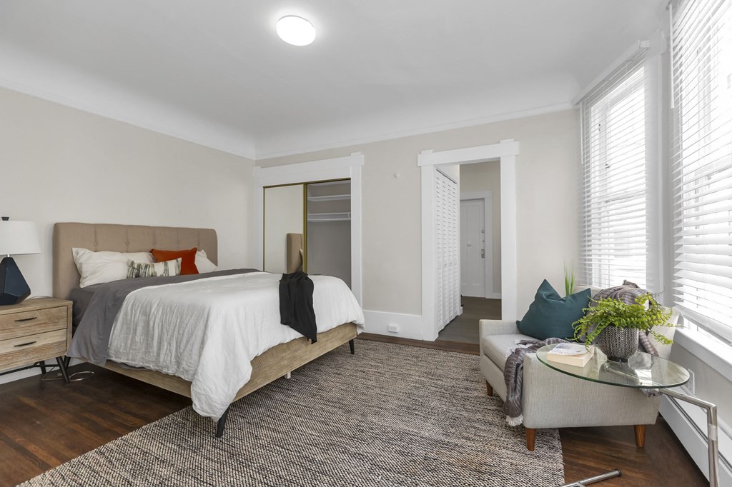 a bedroom with a large bed and a couch