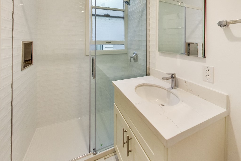 a bathroom with a sink and a shower
