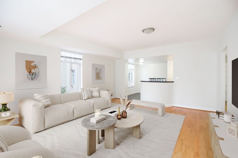 A living room with a white couch and a coffee table.