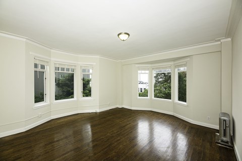 A room with wooden floors and white walls.