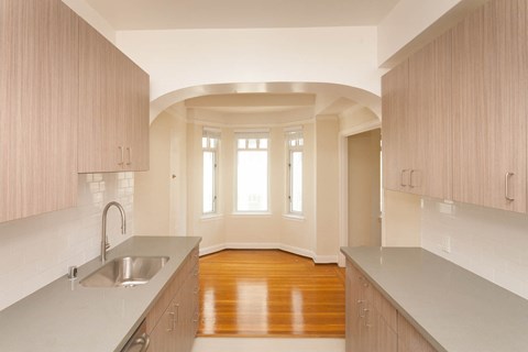 A kitchen with wooden cabinets and a sink.