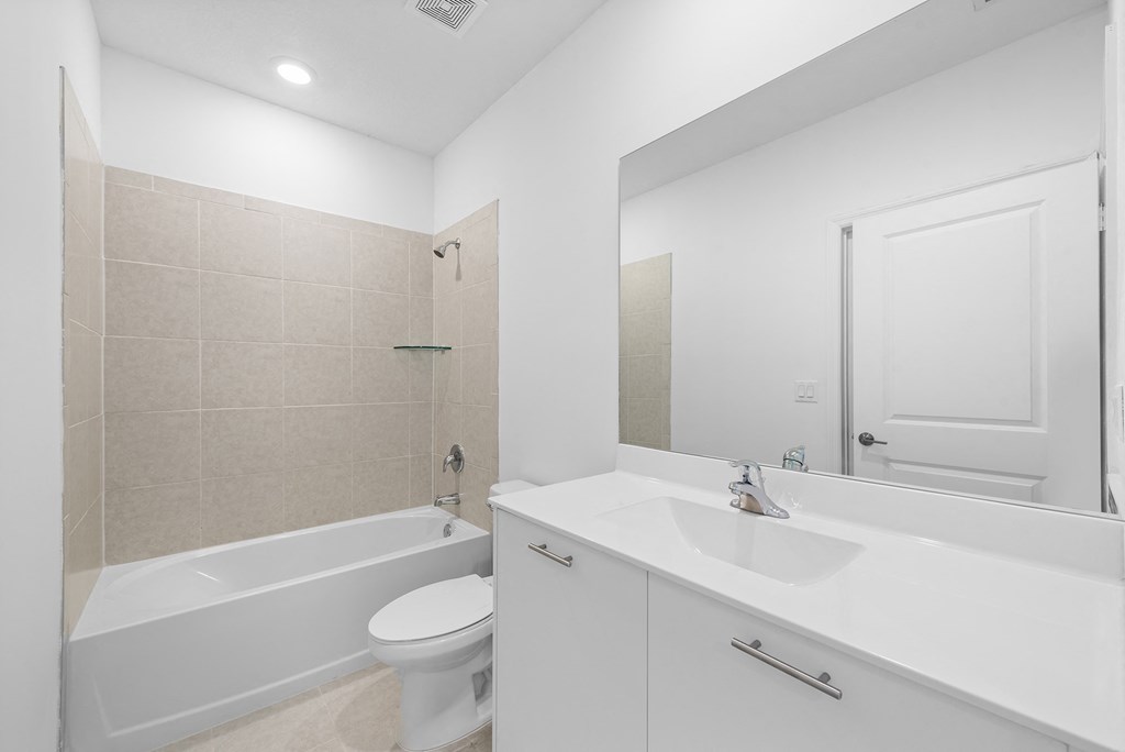 a bathroom with a sink toilet and a tub