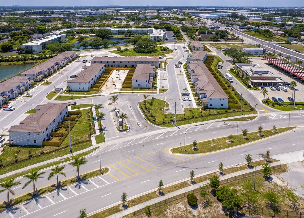 an aerial view of a parking lot with cars and buildings