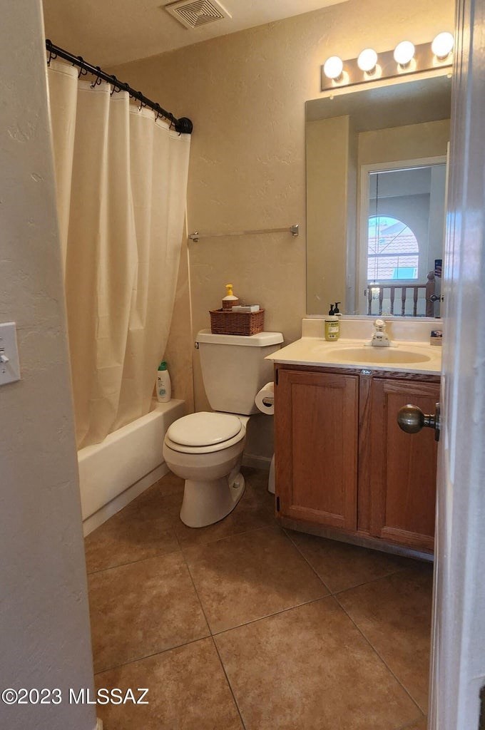 a bathroom with a toilet and a sink and a shower